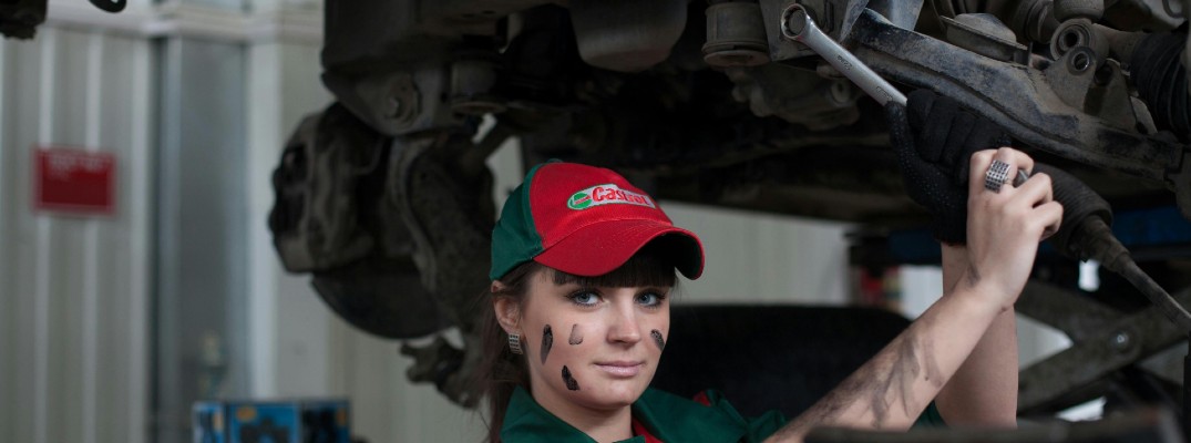 A photo of a person working on a car.