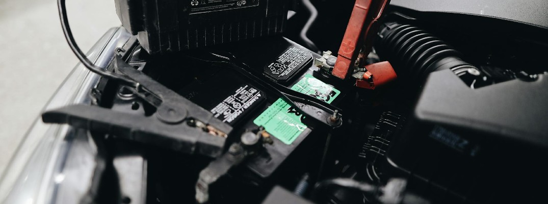 A stock photo of a car battery being jump started.