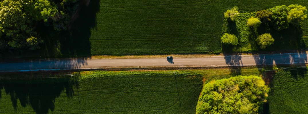 A stock photo of a car on the road during spring.